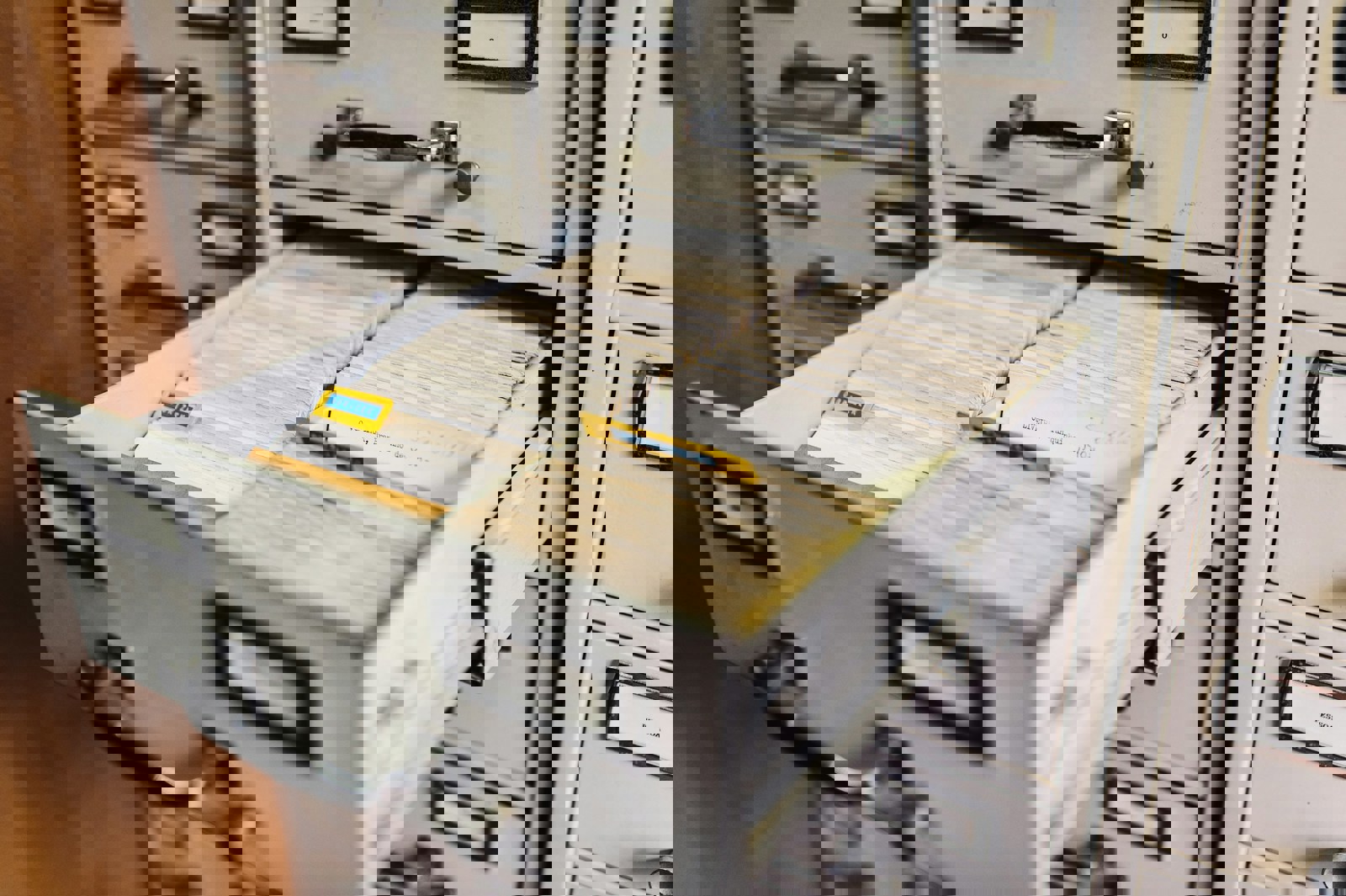 An open filing cabinet filled with files