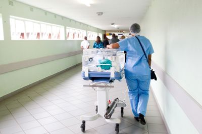 Healthcare professional walking down a corridor